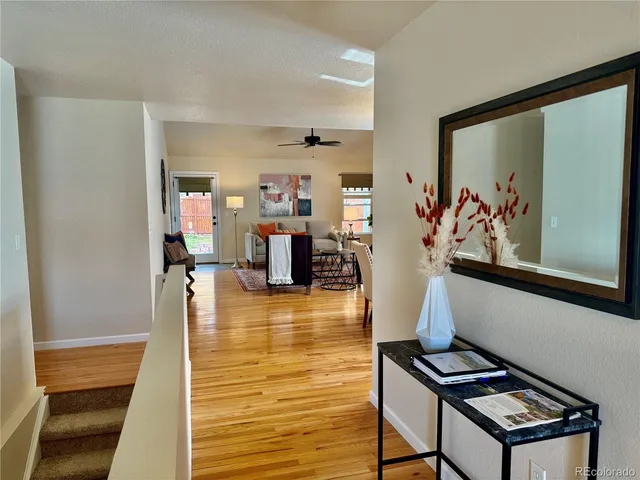 a view of a living room with furniture and flat screen tv