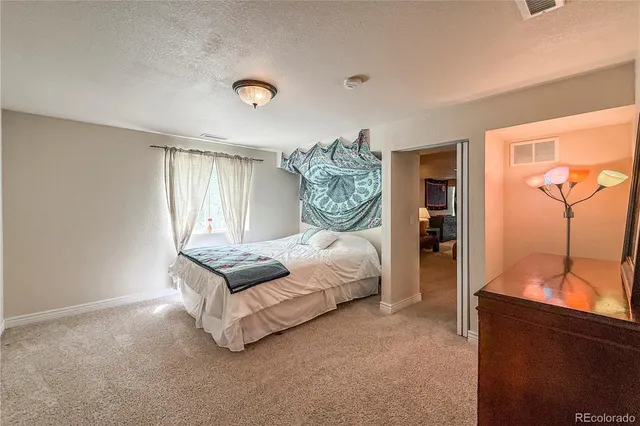 a bedroom with bed and window