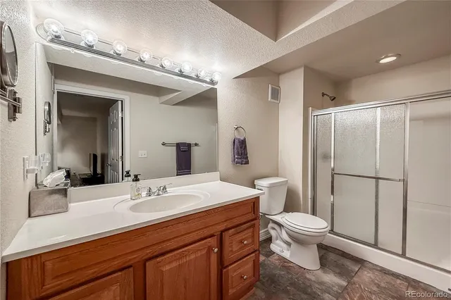 a view of a patio with a table and chairs under a large umbrella