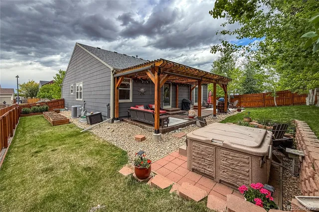 a view of a backyard with a patio table and chairs