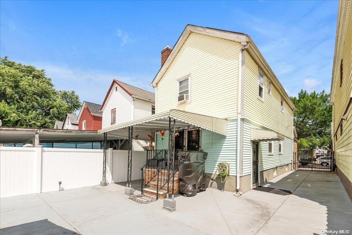 91-26 79th Street Queens, NY 11421 - Photo 15 of 20 a view of a house with a patio
