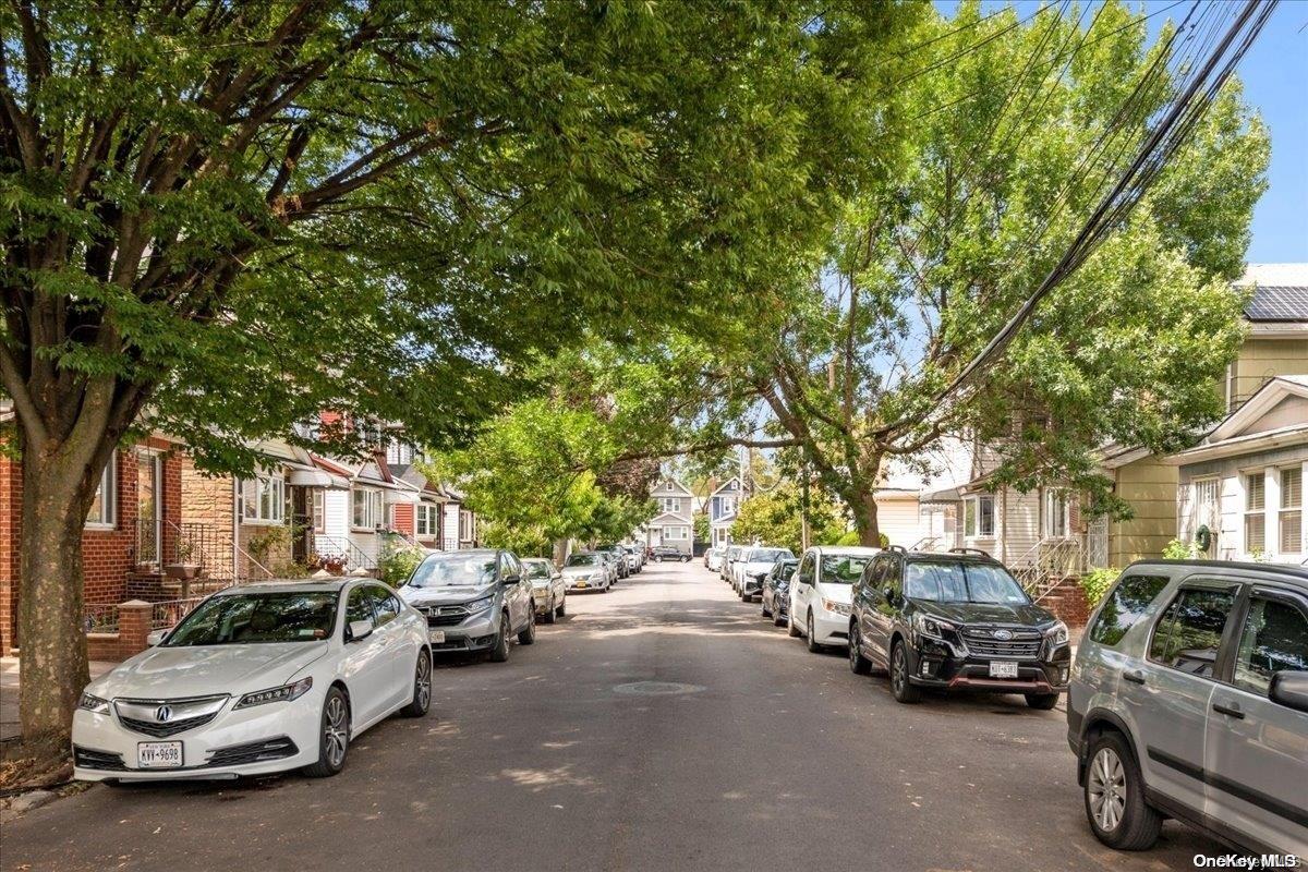91-26 79th Street Queens, NY 11421 - Photo 19 of 20 a view of a cars park in front of a house