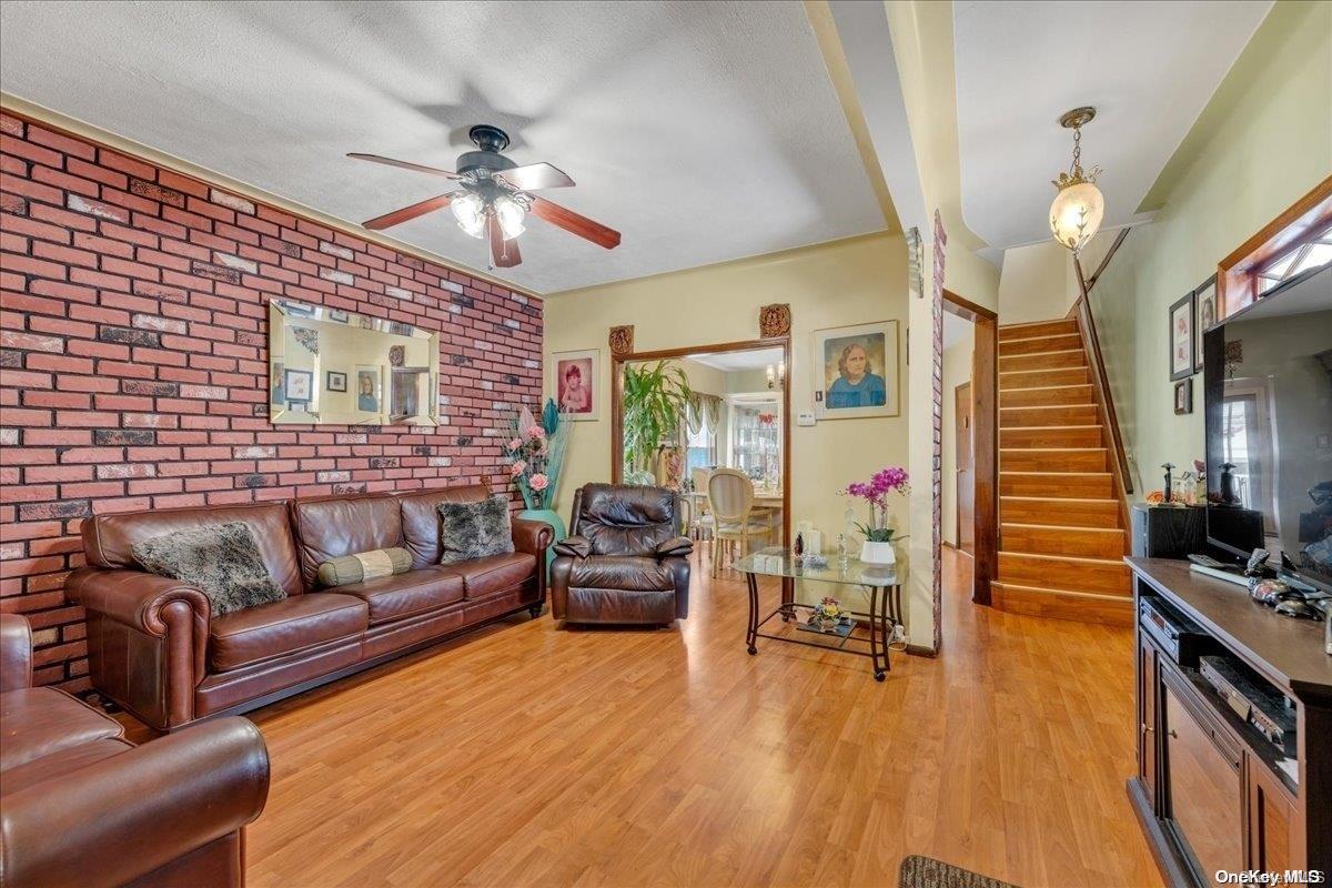 91-26 79th Street Queens, NY 11421 - Photo 3 of 20 a living room with furniture and wooden floor