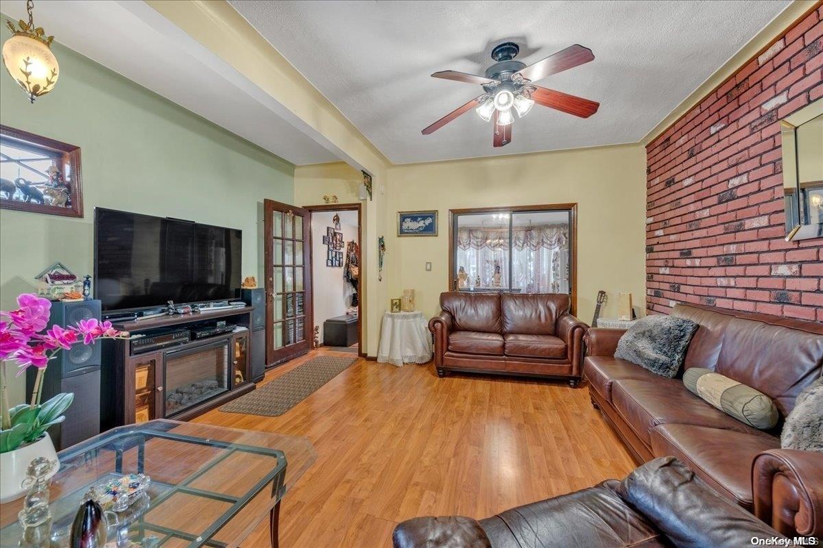 91-26 79th Street Queens, NY 11421 - Photo 5 of 20 a living room with furniture and a flat screen tv