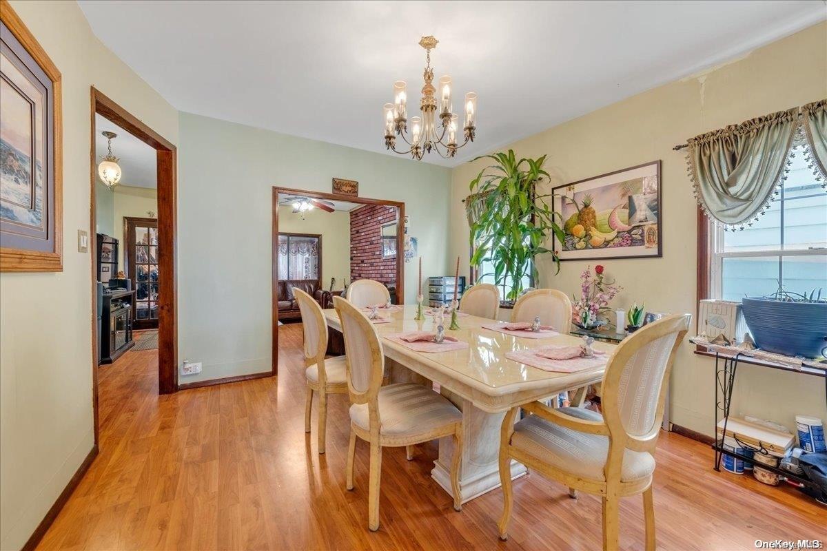 91-26 79th Street Queens, NY 11421 - Photo 6 of 20 a view of a dining room with furniture wooden floor and chandelier
