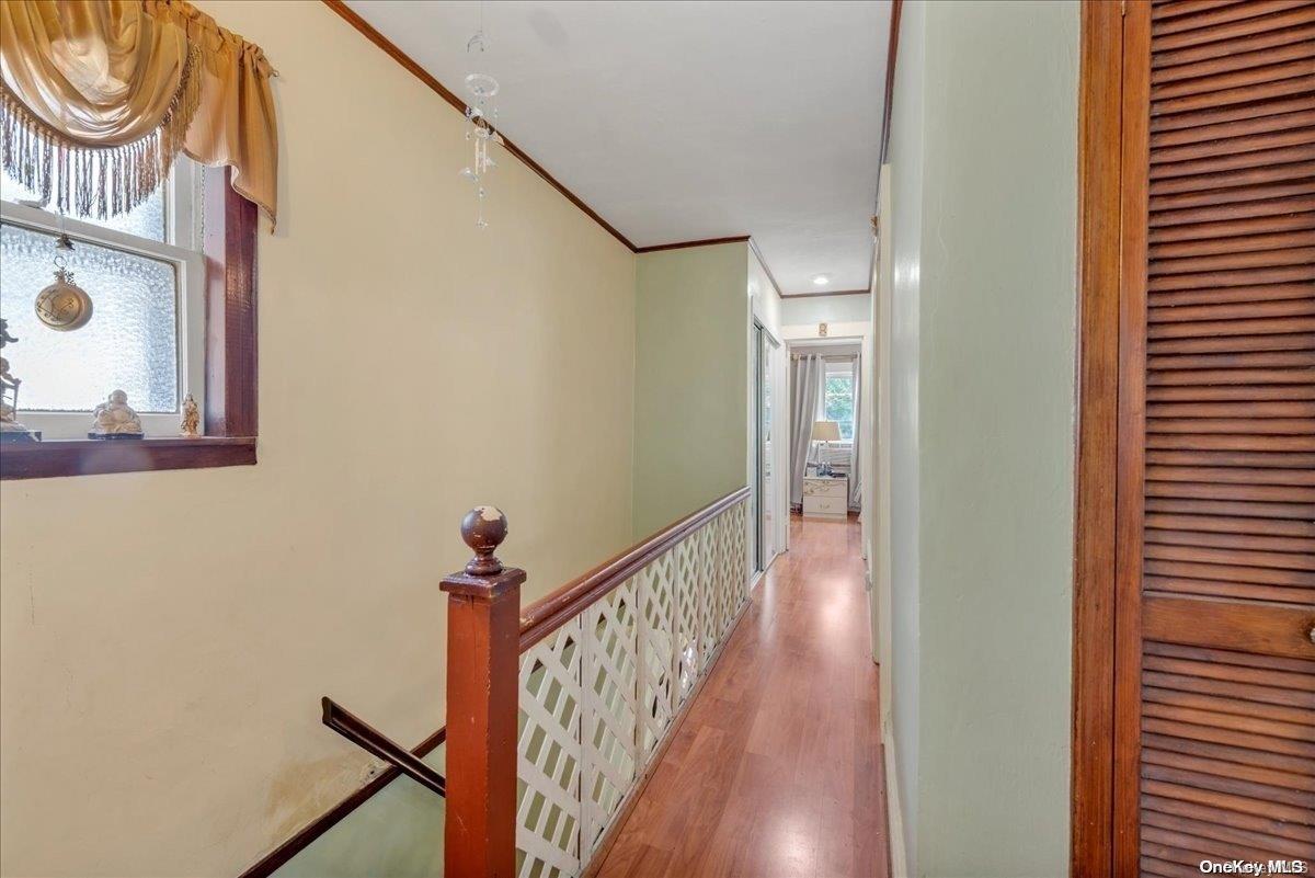 91-26 79th Street Queens, NY 11421 - Photo 9 of 20 a view of a hallway with wooden floor and entryway