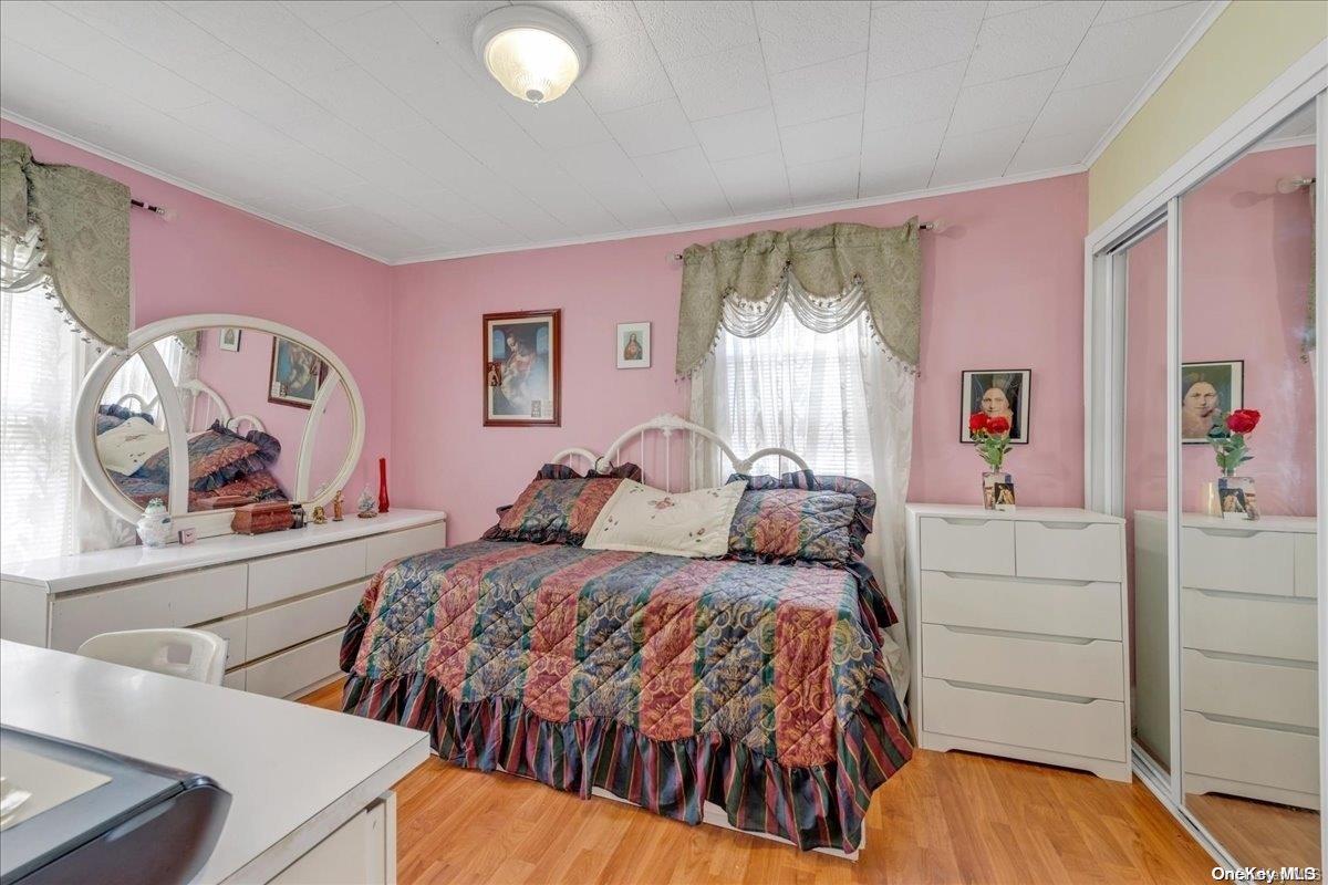 91-26 79th Street Queens, NY 11421 - Photo 10 of 20 a bedroom with a bed and a window