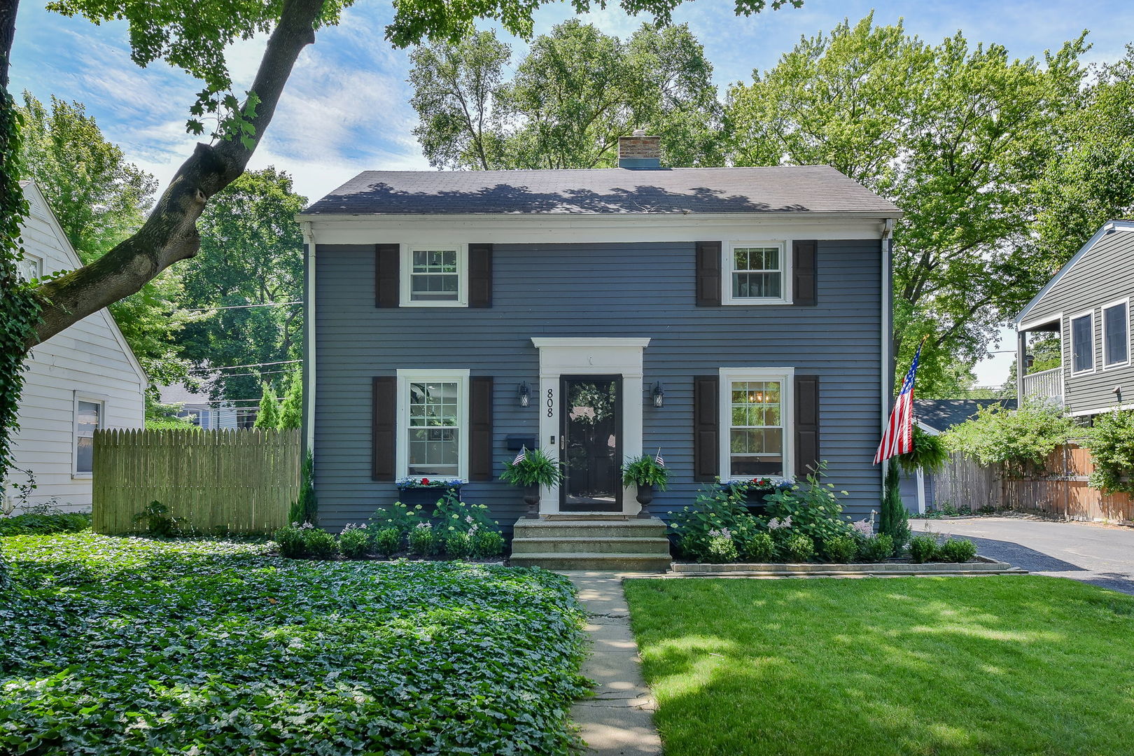 a front view of a house with a garden