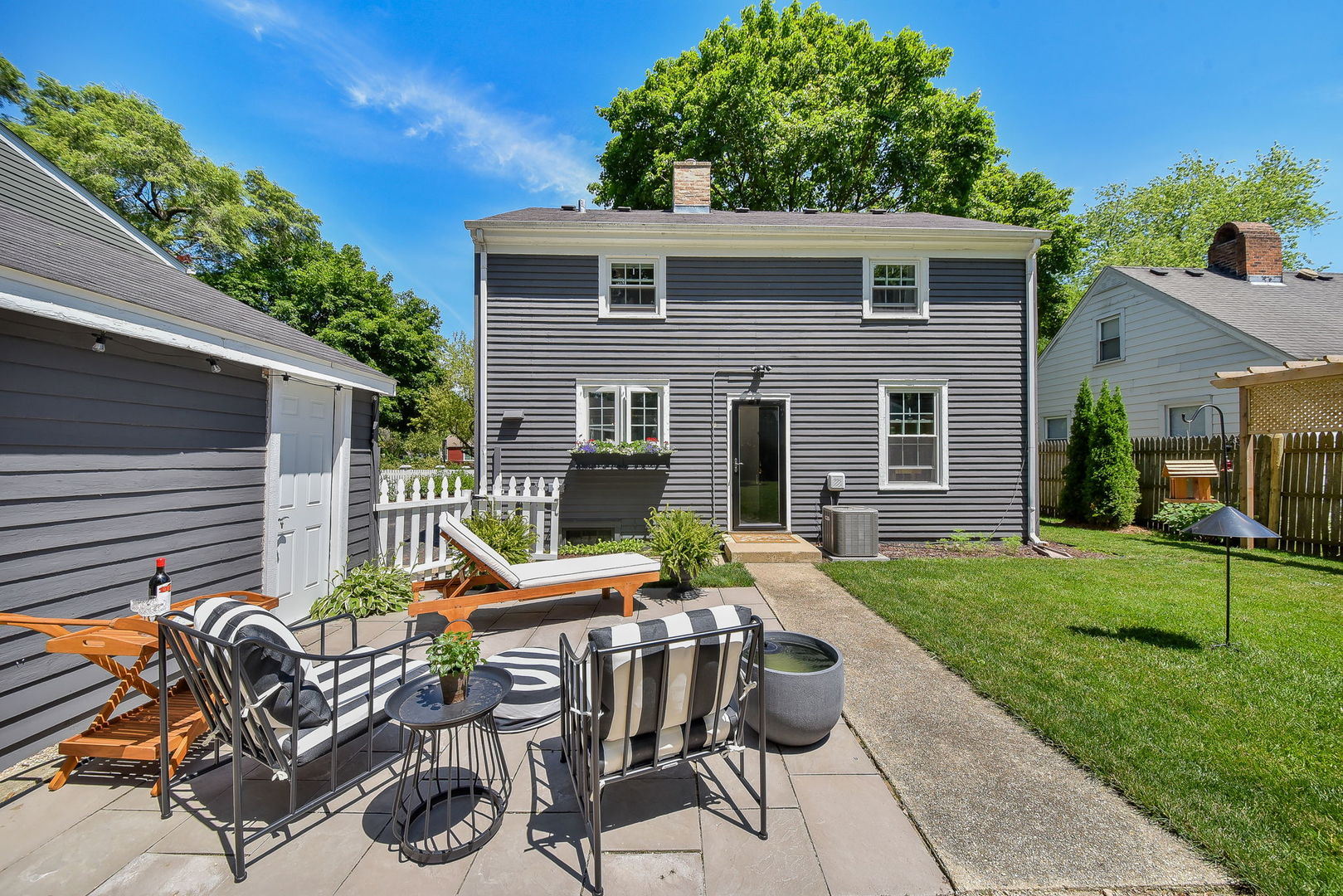 808 Anderson Boulevard Geneva, IL 60134 - Photo 23 of 30 a view of a patio with table and chairs and potted plants