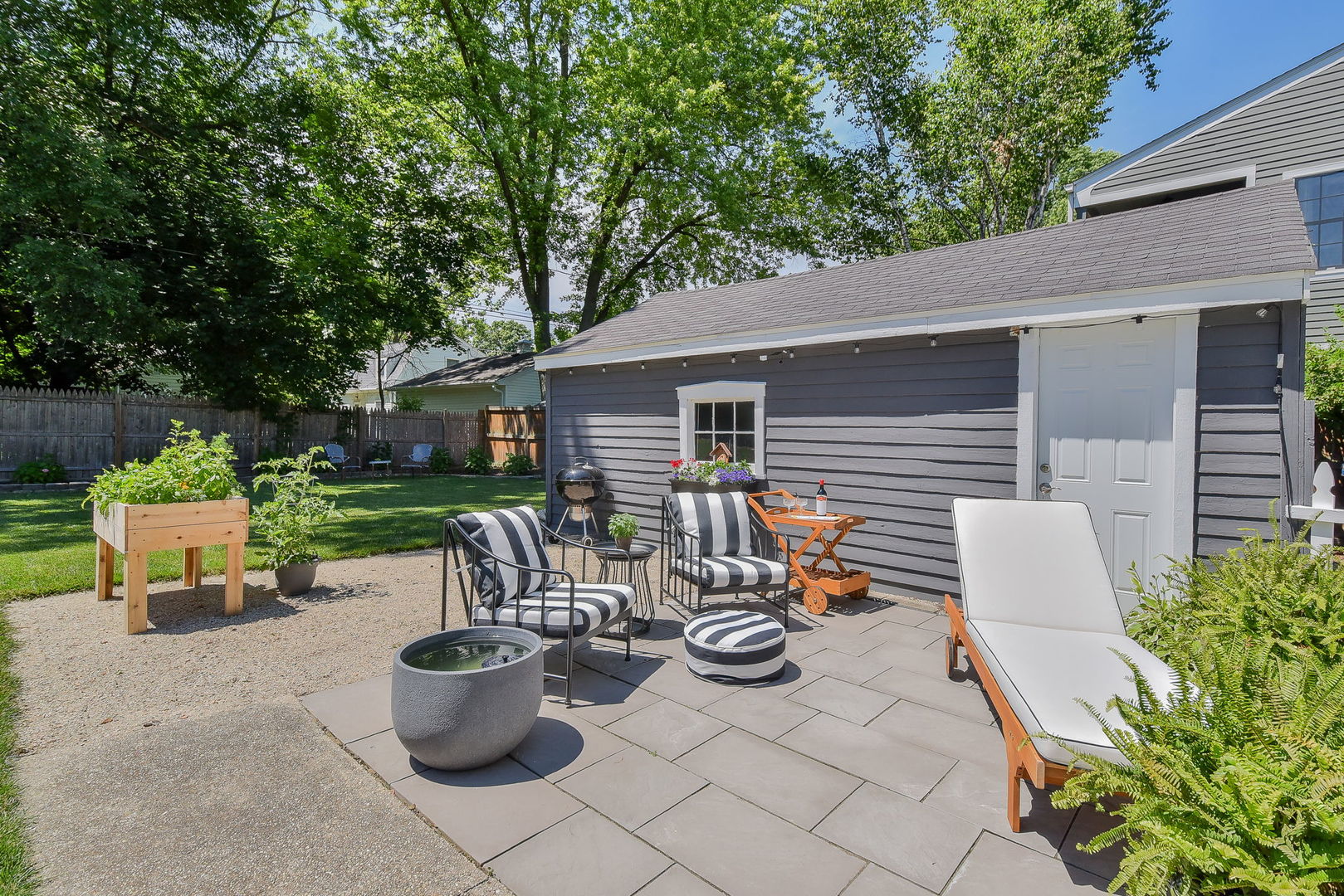 808 Anderson Boulevard Geneva, IL 60134 - Photo 24 of 30 a view of a patio with table and chairs potted plants and a large tree