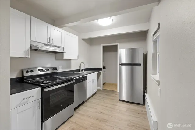 a kitchen with a stove and a refrigerator