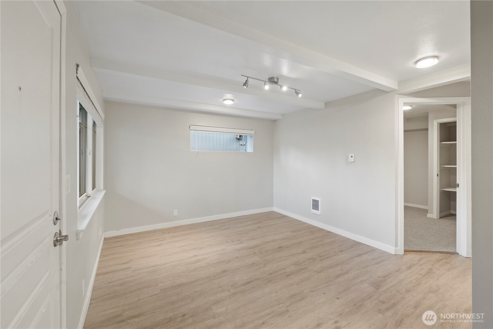 4811 South 252nd Place Kent, WA 98032 - Photo 3 of 6 an empty room with wooden floor and windows