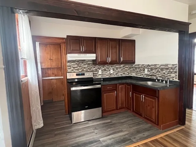 a kitchen with stainless steel appliances granite countertop a stove and a refrigerator