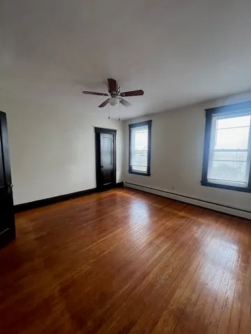 a view of wooden floor and windows in a room