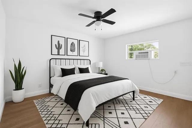 a bedroom with a large bed and a chandelier
