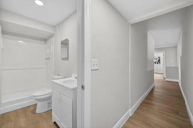 a bathroom with a sink toilet and shower