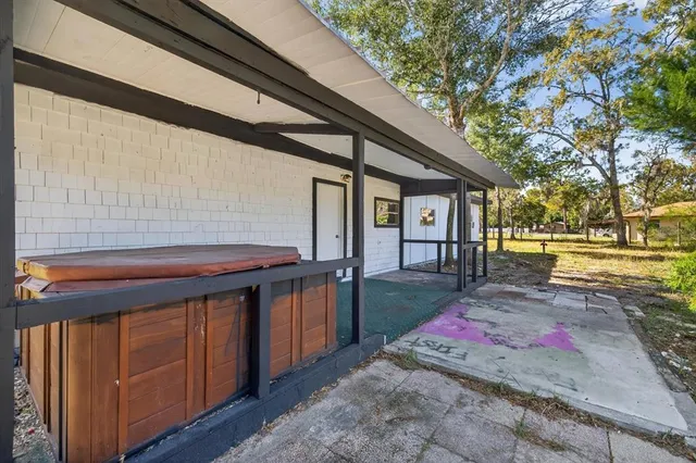 a view of a field with an trees in the background