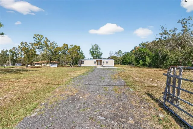 a view of a house with a yard and a garage