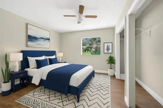 a bedroom with bed and wooden floor