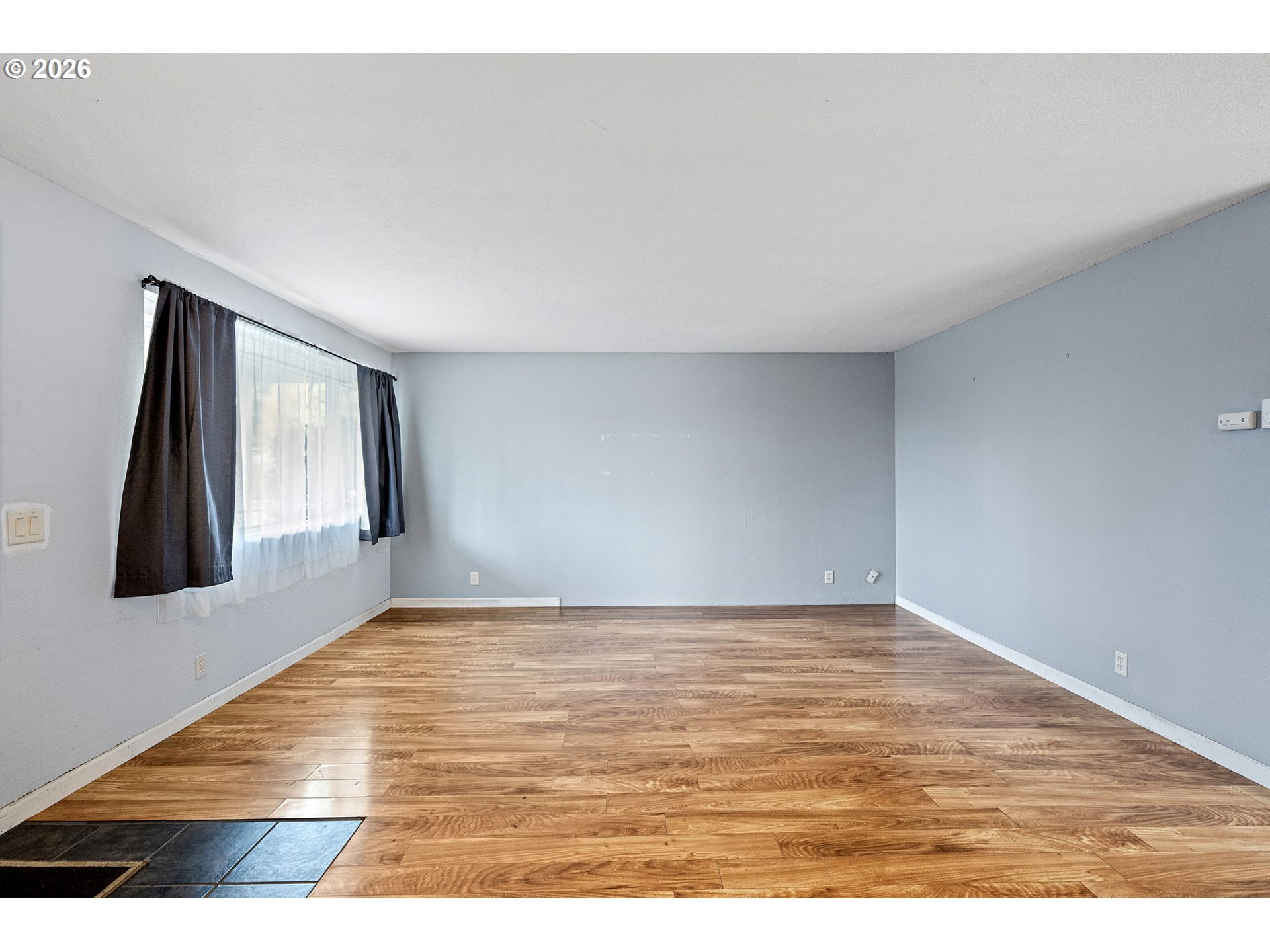 775 54th Street Springfield, OR 97478 - Photo 11 of 31 a view of an empty room with wooden floor and a window