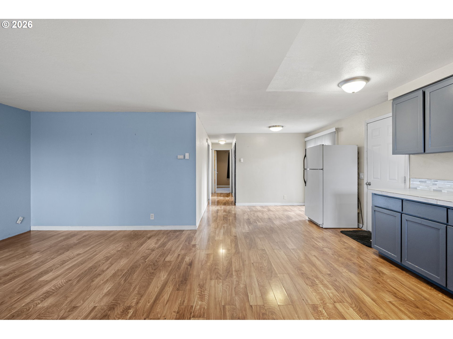 775 54th Street Springfield, OR 97478 - Photo 8 of 31 a view of an empty room with kitchen appliances and wooden floor