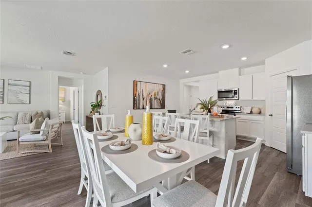 a view of a dining room with furniture and wooden floor