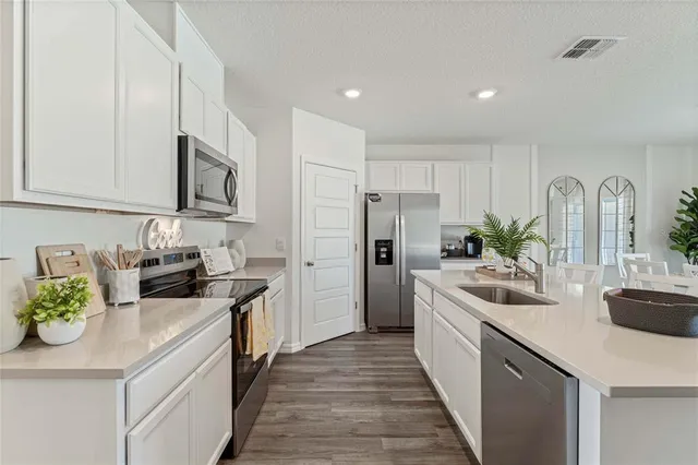 a kitchen with a sink stove and refrigerator