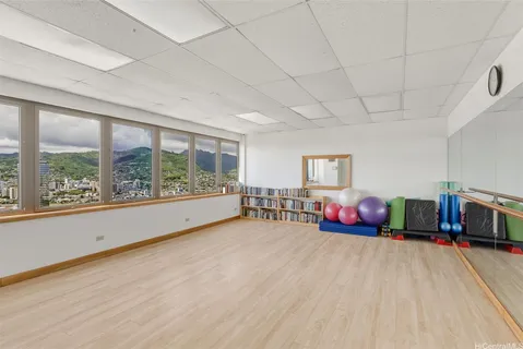 a view of a livingroom with furniture hardwood floor and windows