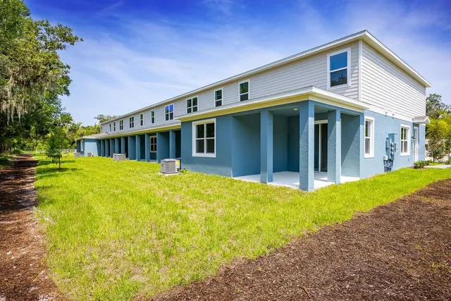 a view of a house with pool and garden
