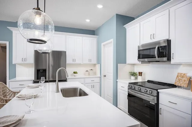 a kitchen with a sink stove and refrigerator