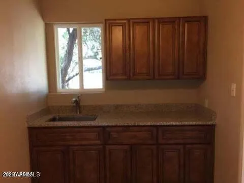 a kitchen with granite countertop cabinets sink and window