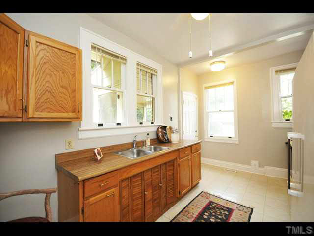 1821 White Oak Road Raleigh, NC 27608 - Photo 9 of 25 a bathroom with a sink and a window