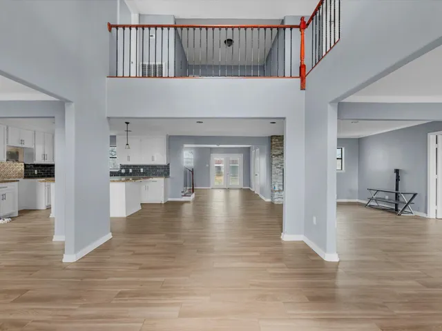 a view of a livingroom with wooden floor and a fireplace