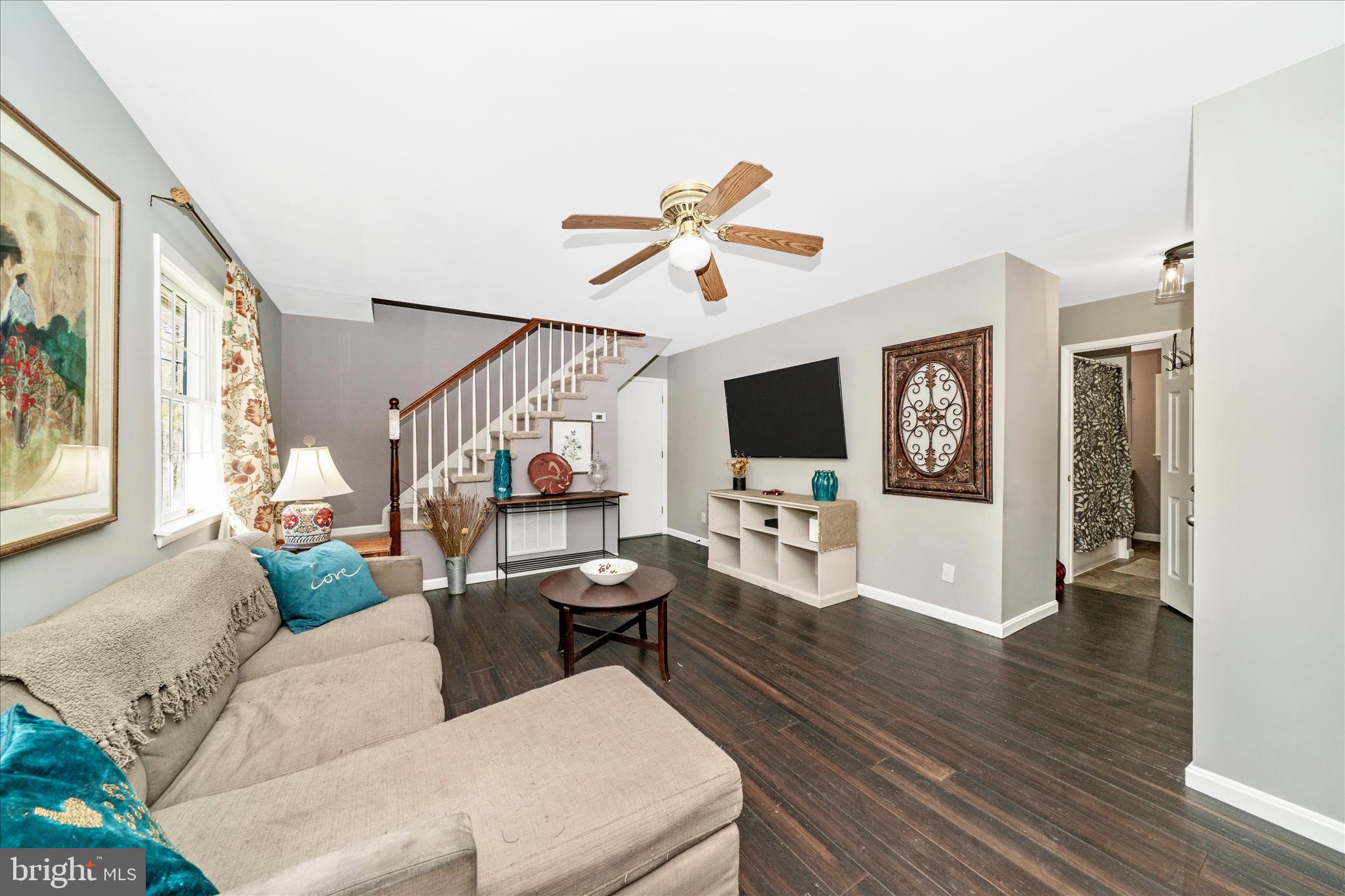 15211 Avery Road Rockville, MD 20855 - Photo 13 of 60 a living room with furniture a flat screen tv and a wall painting