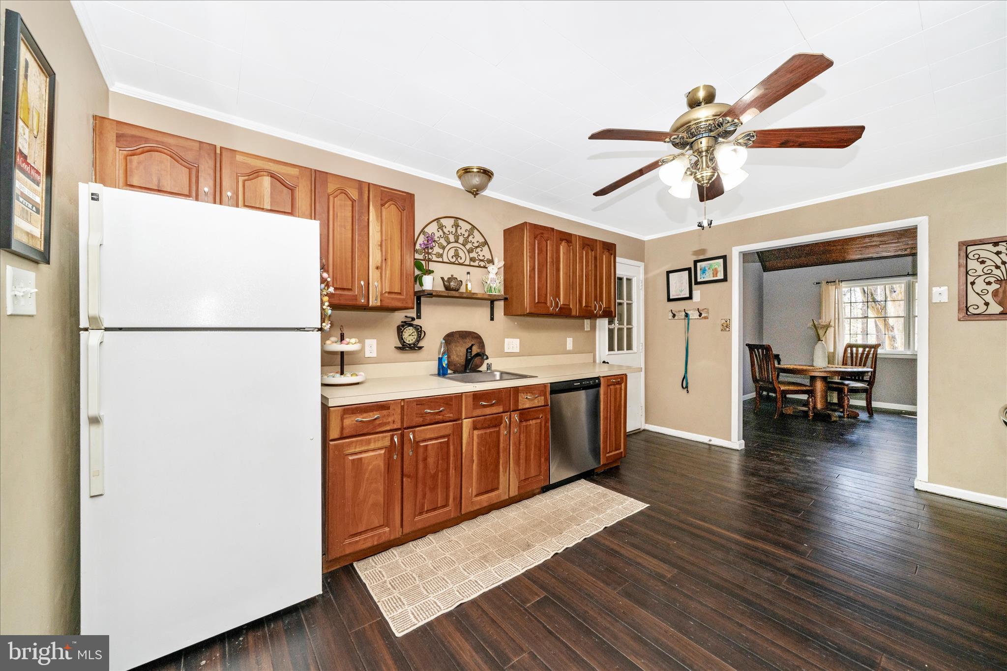 15211 Avery Road Rockville, MD 20855 - Photo 16 of 60 a kitchen with kitchen island wooden floors appliances and white cabinets