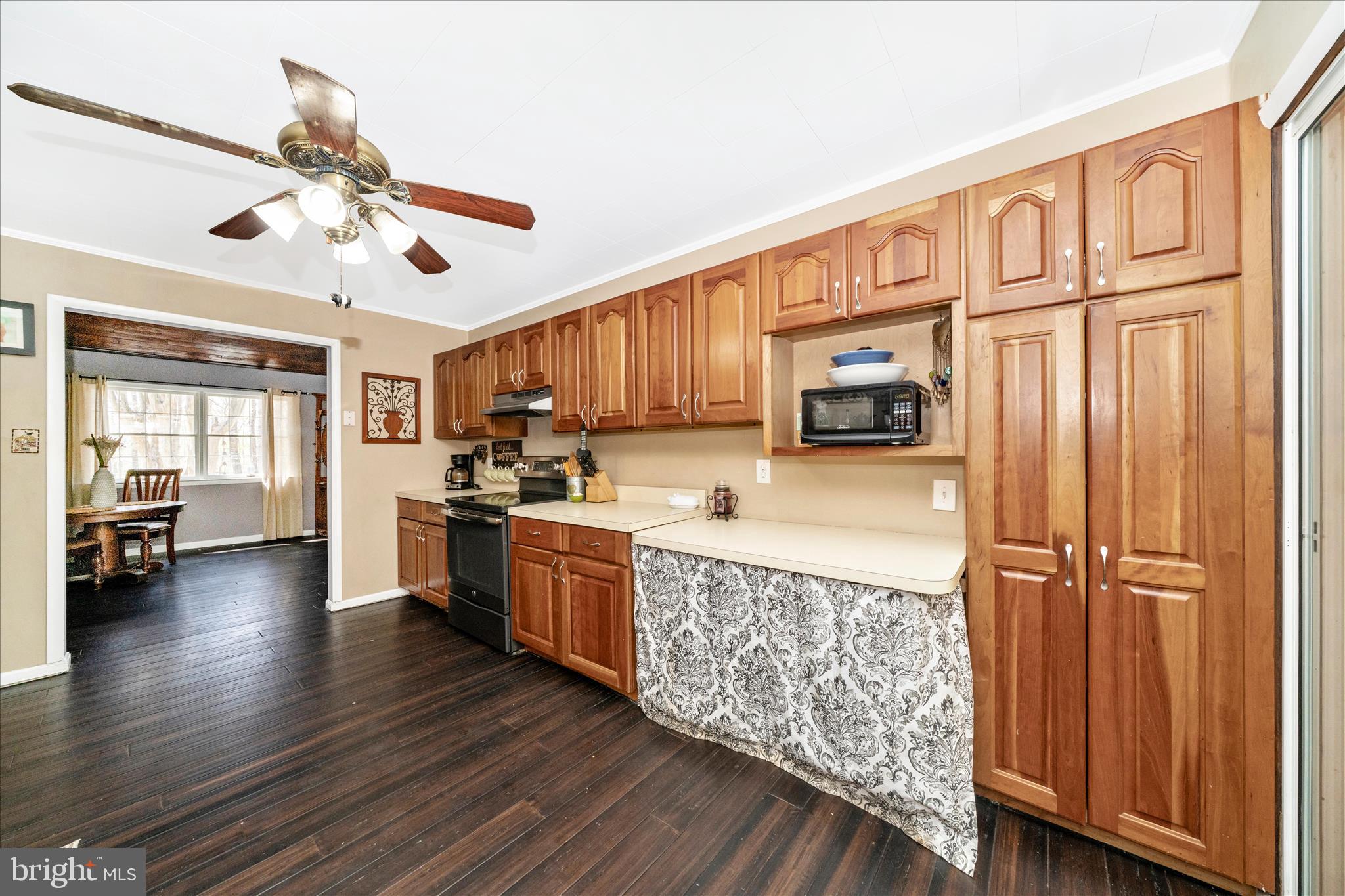15211 Avery Road Rockville, MD 20855 - Photo 17 of 60 a kitchen with stainless steel appliances granite countertop a refrigerator oven stove a sink dishwasher and wooden cabinets with wooden floor