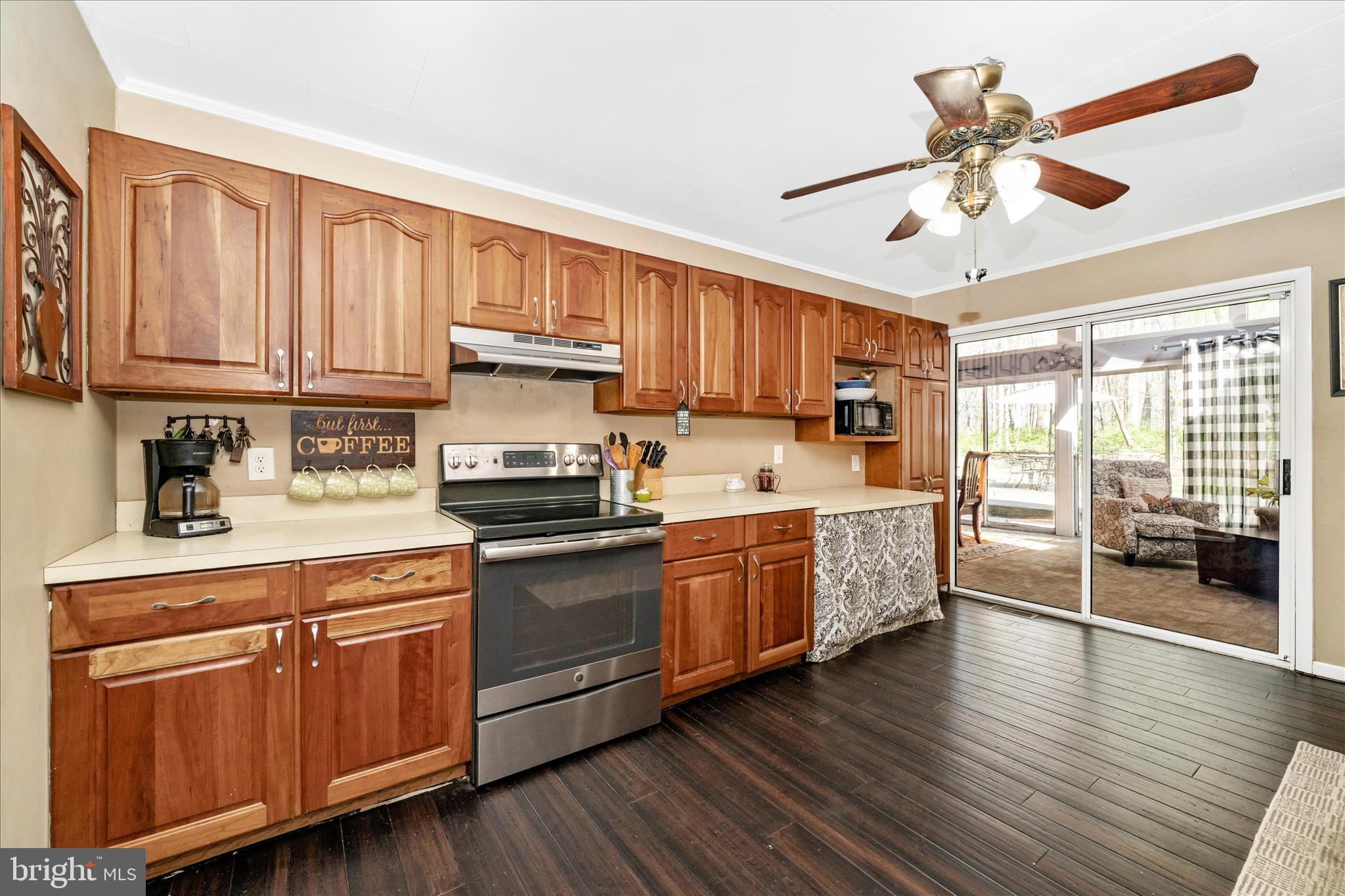 15211 Avery Road Rockville, MD 20855 - Photo 18 of 60 a kitchen with stainless steel appliances granite countertop wooden cabinets a sink a stove a refrigerator and island with wooden floor