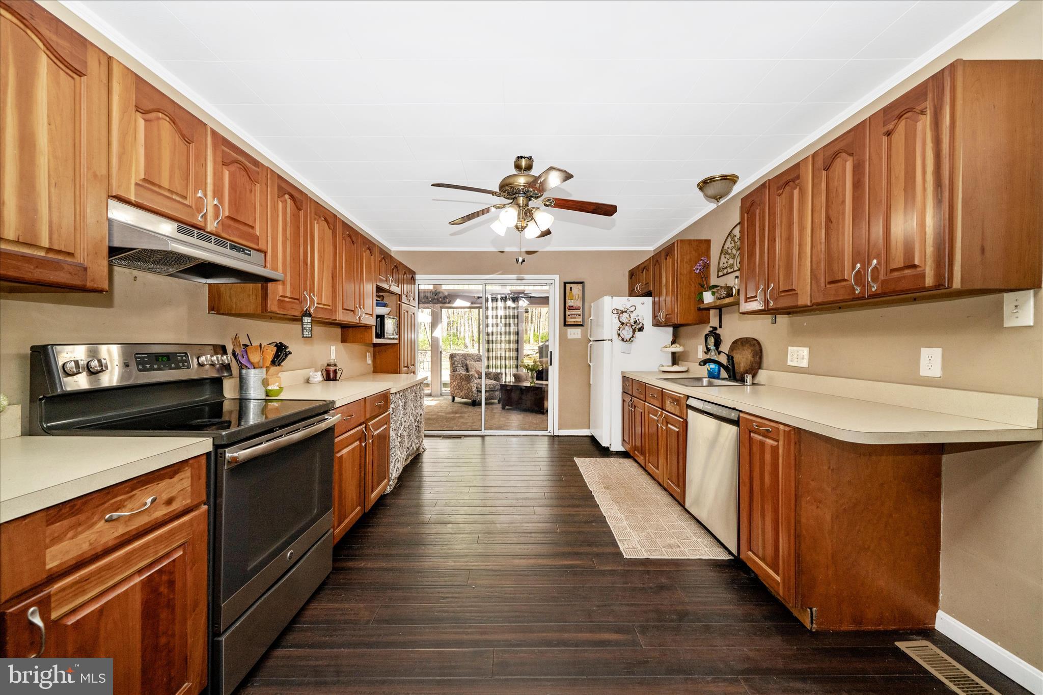 15211 Avery Road Rockville, MD 20855 - Photo 19 of 60 a kitchen with stainless steel appliances granite countertop a stove a sink dishwasher and a refrigerator
