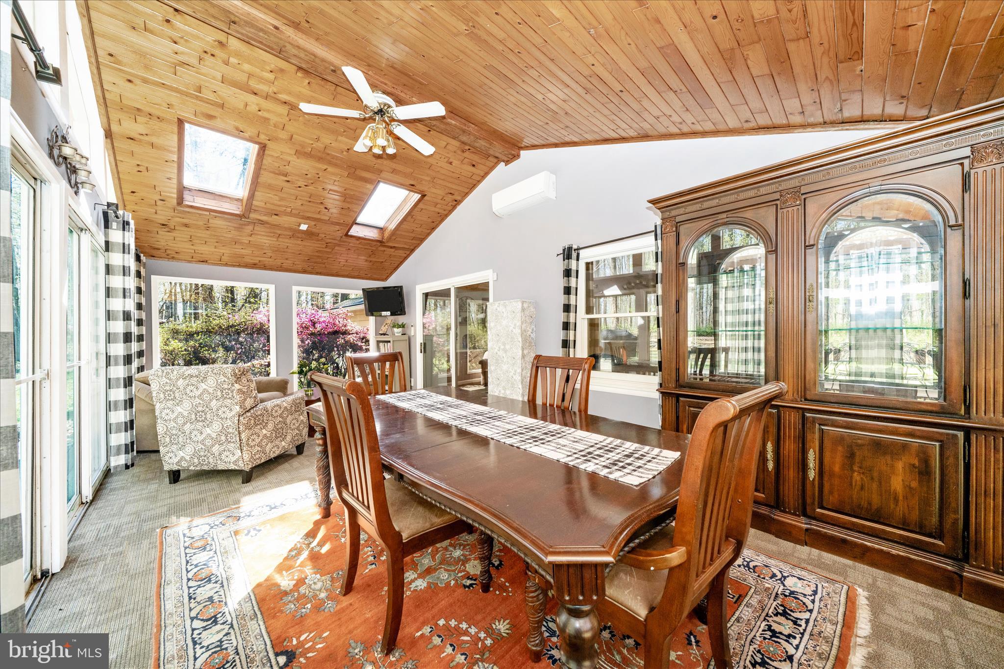 15211 Avery Road Rockville, MD 20855 - Photo 22 of 60 a view of a dining room with furniture large windows and wooden floor