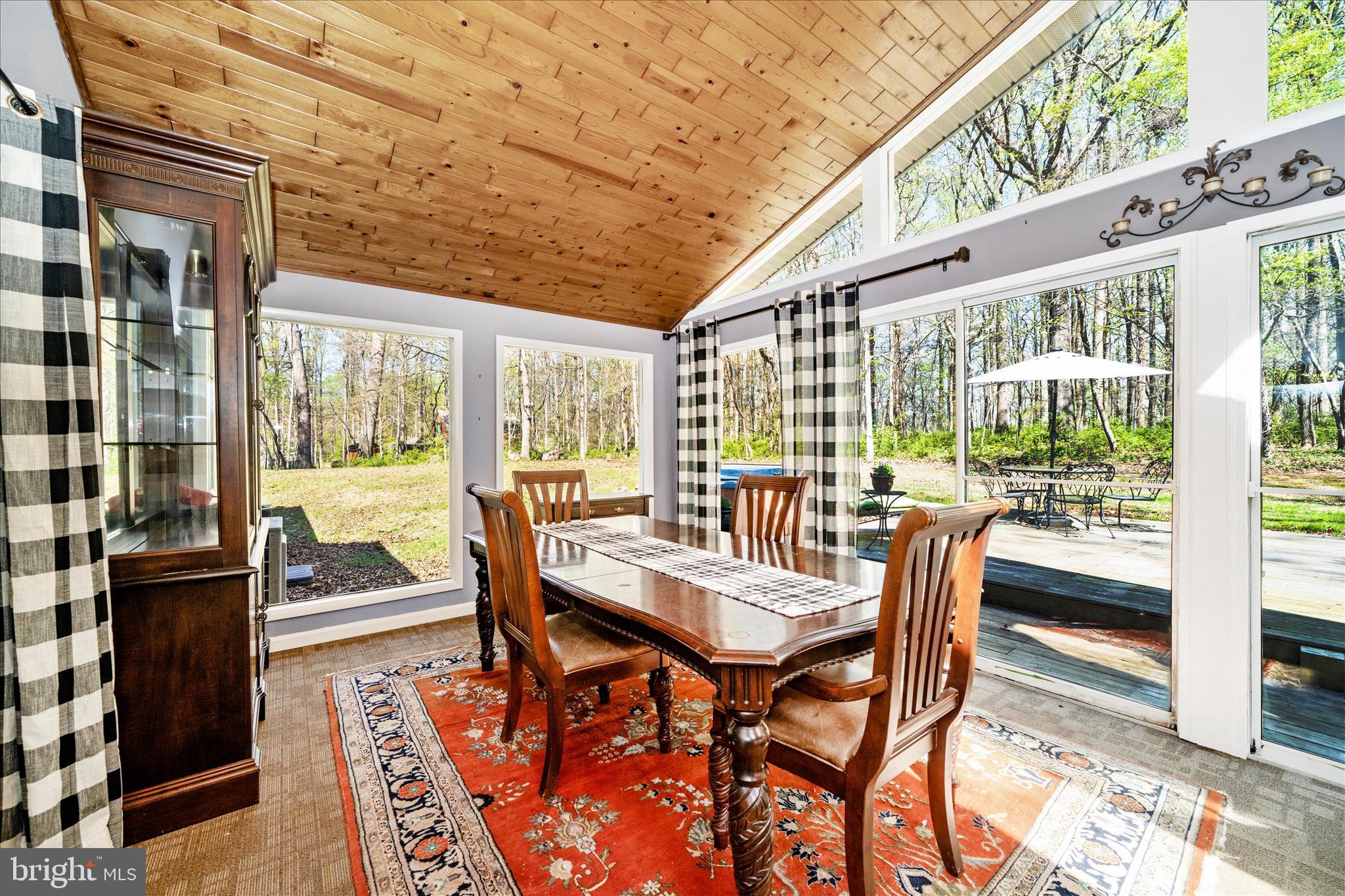 15211 Avery Road Rockville, MD 20855 - Photo 23 of 60 a view of a dining room with furniture large windows and wooden floor
