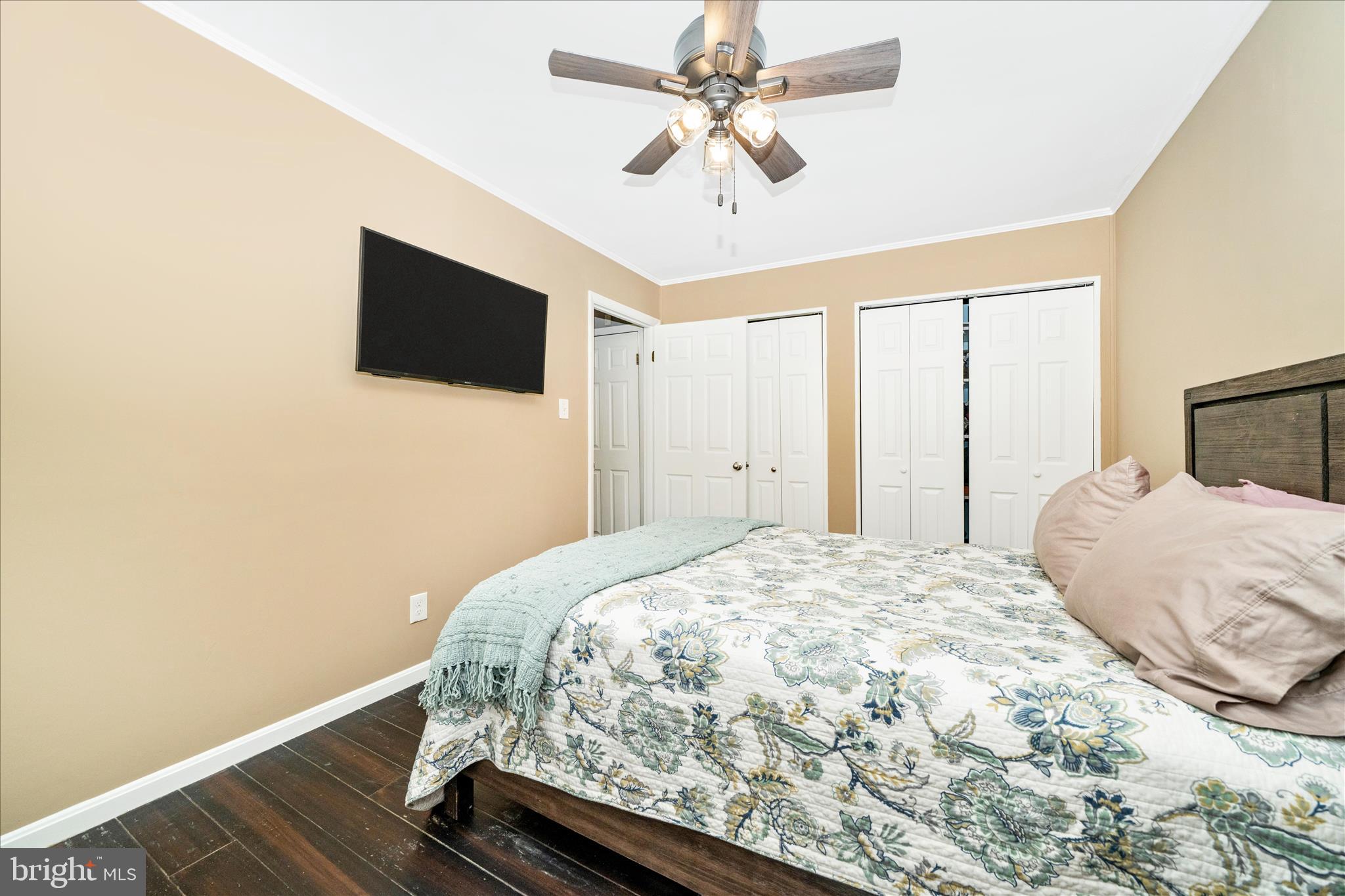15211 Avery Road Rockville, MD 20855 - Photo 28 of 60 a bedroom with a bed and a flat screen tv