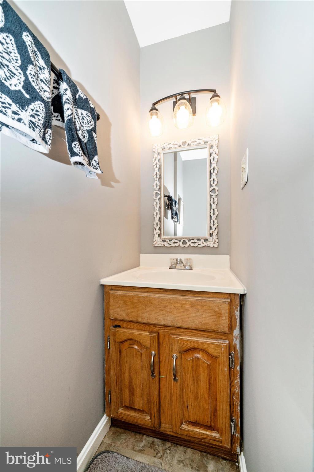 15211 Avery Road Rockville, MD 20855 - Photo 31 of 60 a bathroom with a sink and a mirror