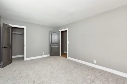 an empty room with closet area
