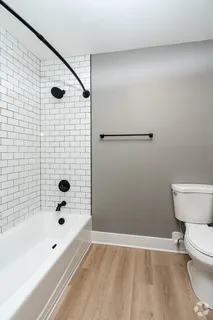 a bathroom with a bathtub and toilet