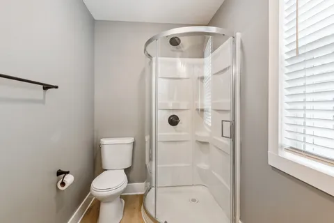 a bathroom with a toilet and a shower