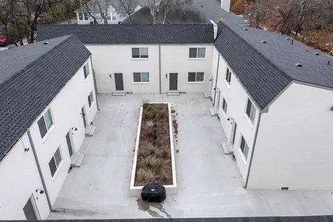 an aerial view of a house with a yard basket ball court and outdoor seating