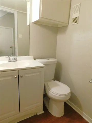 a bathroom with a sink toilet and mirror