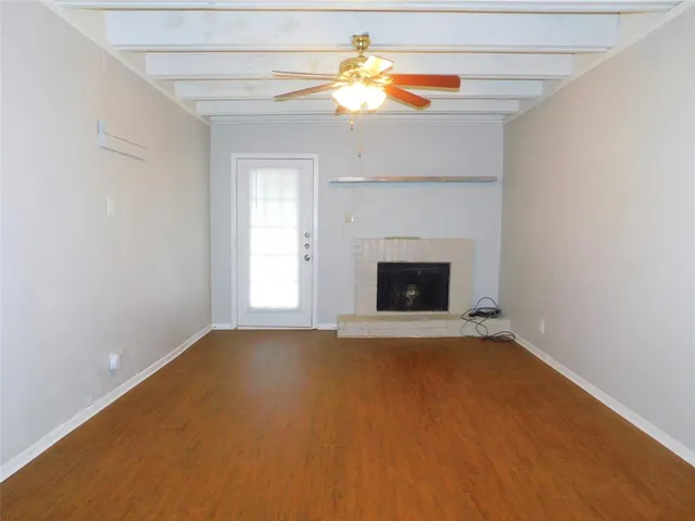 a view of an empty room with a fireplace