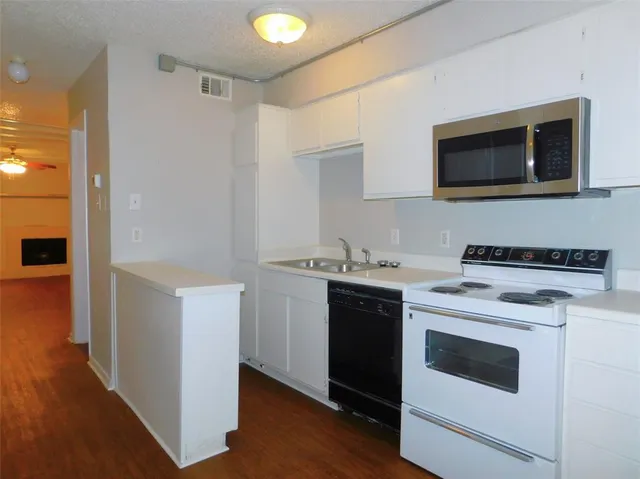 a kitchen with a stove and a microwave