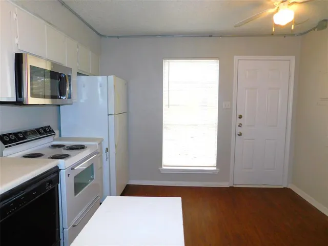 a kitchen with a stove and a microwave
